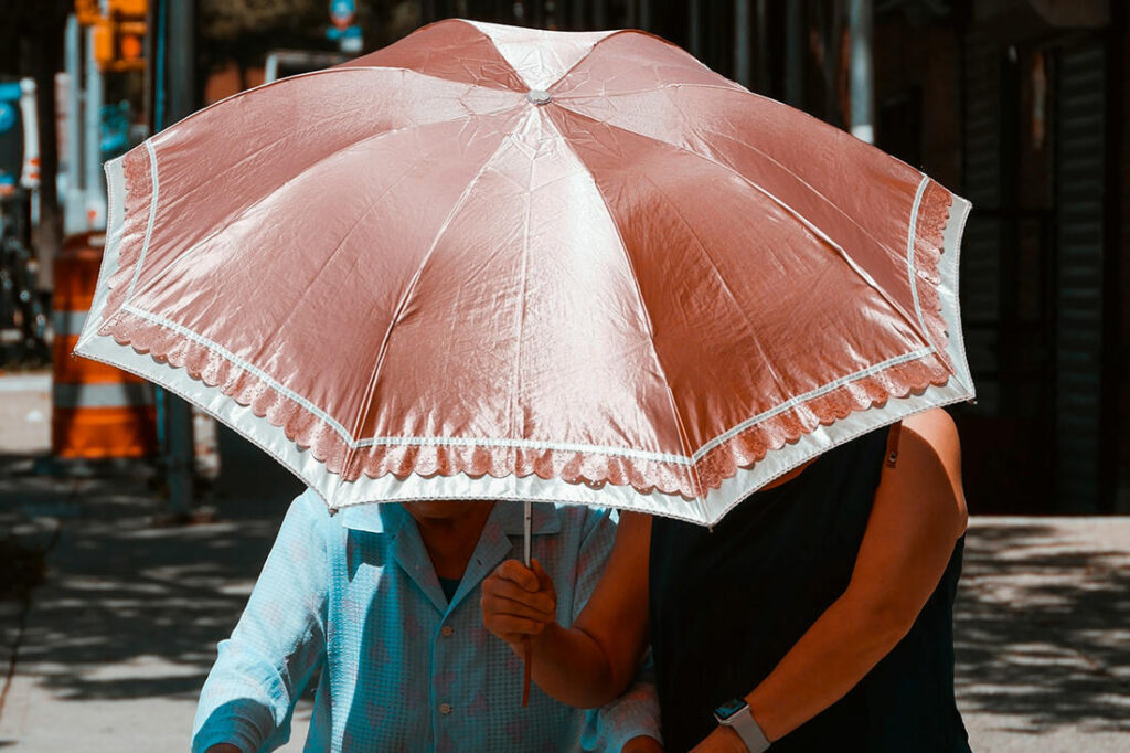 Copeland Counselling - The Fawn Response To Trauma - Shielding Friend With Umbrella